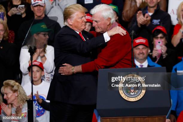 President Donald Trump embraces former Indiana University basketball coach Bobby Knight during a campaign rally on November 2, 2018 at Southport High...