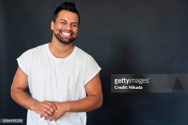 cheerful hispanic young man - male model facial expression stock pictures, royalty-free photos & images
