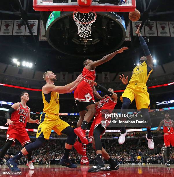 Victor Oladipo of the Indiana Pacers shoots over Chandler Hutchison and Cristiano Felicio of the Chicago Bulls on his way to a game-high 25 points at...