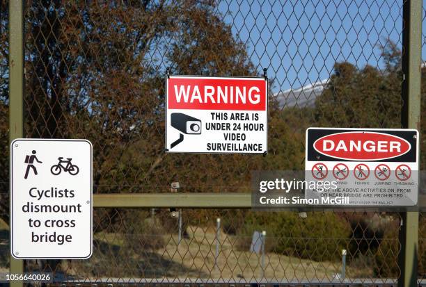 warning signs on a metal fence near a bridge - private property stock pictures, royalty-free photos & images