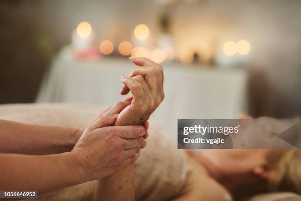 massage for seniors - hand massage stock pictures, royalty-free photos & images