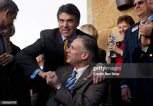 Texas Gov. RIck Perry greets Texas Lt. Gov. Greg Abbott during a conservative rally October 18, 2010 in Austin, Texas. Perry is seeking his fourth...