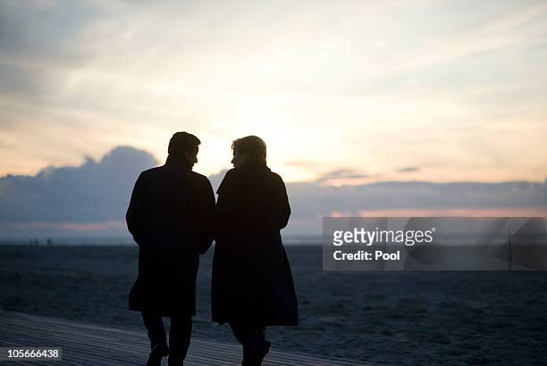 In this photo provided by the German Government Press Office, German Chancellor Angela Merkel walks together with French President Nicolas Sarkozy at...