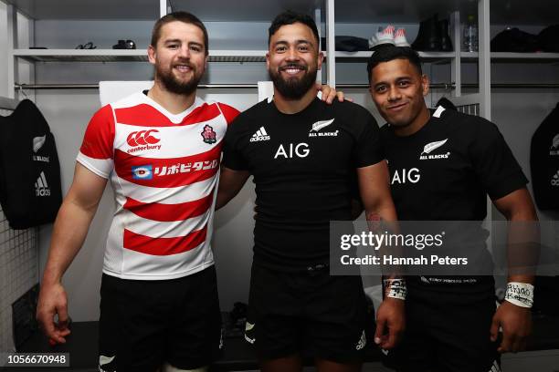 Dane Coles, Matt Proctor and Te Toiroa Tahuriorangi of the All Blacks celebrate in the changing room after winning the test match between Japan and...