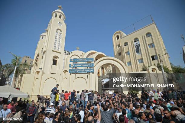 Crowds gather as Coptic Christians carry the coffins of victims killed in an attack a day earlier, following a morning ceremony at the Prince Tadros...