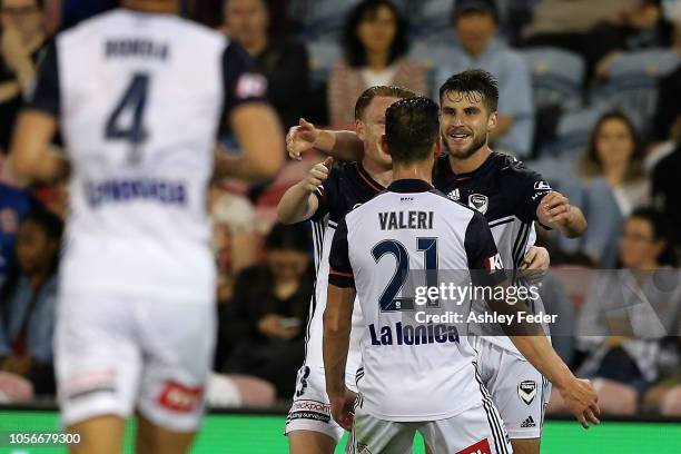 Terry Antonis of Melbourne Victory celebrates his goal with team mates during the round three A-League match between the Newcastle Jets and the...