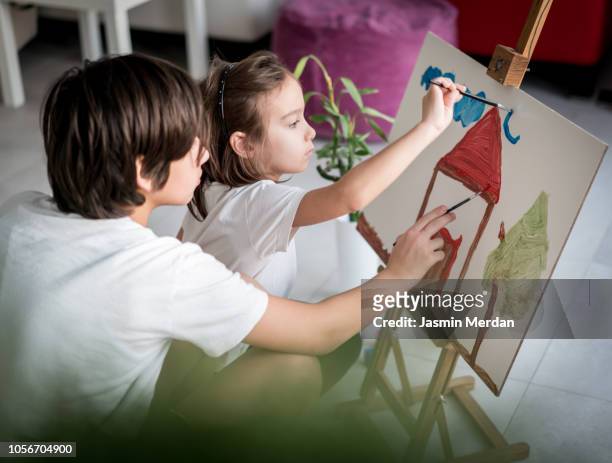 Children at home painting on canvas at home