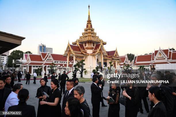 Mourners from Thailand's elite arrives at the Wat Thepsirin Buddhist temple in Bangkok for the funeral ceremony of Leicester City's Thai owner and...