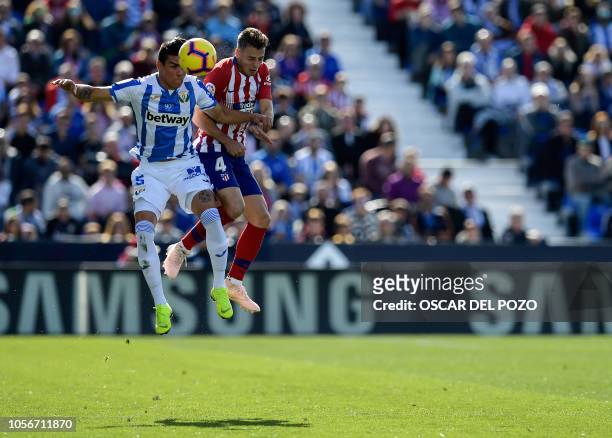 Atletico Madrid's Colombian defender Santiago Arias vies with Leganes' Argentinian defender Jonathan Silva during the Spanish league football match...