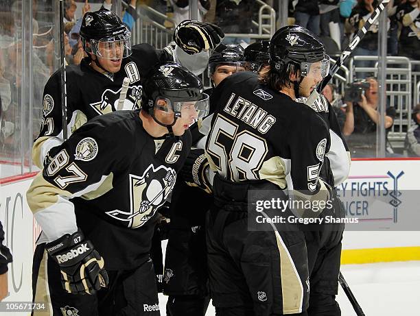 Sidney Crosby of the Pittsburgh Penguins celebrates his goal with Evgeni Malkin and Kris Letang against the Ottawa Senators on October 18, 2010 at...