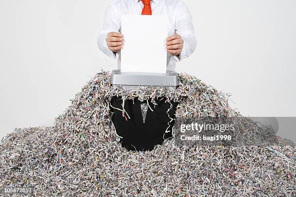businessman shredding documents - annihilation stockfoto's en -beelden