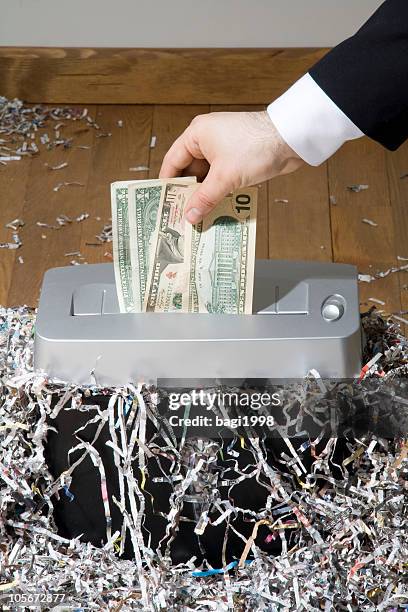 man shredding one hundred dollar banknote - paper shredder stock pictures, royalty-free photos & images