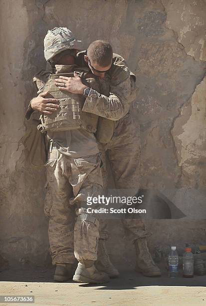 Marine Cpl.Zachary Weber of Mt. Healthy, Ohio comforts LCpl. Matthew Lucas of Muncy, Pennsylvania with India Battery, 3rd Battalion, 12th Marine...