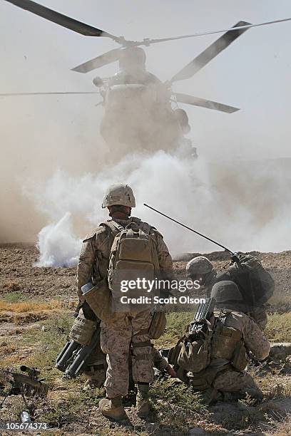 Marines prepare to carry Cpl. Jorge Villarreal of San Antonio, Texas with India Battery, 3rd Battalion, 12th Marine Regiment to a MEDEVAC helicopter...