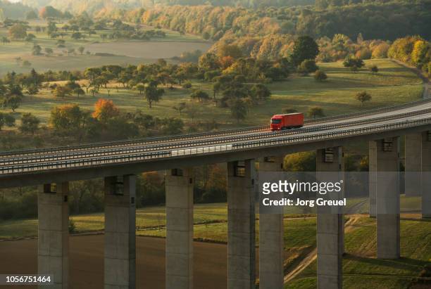 truck on autobahn bridge (dawn) - european landscapes stock-fotos und bilder