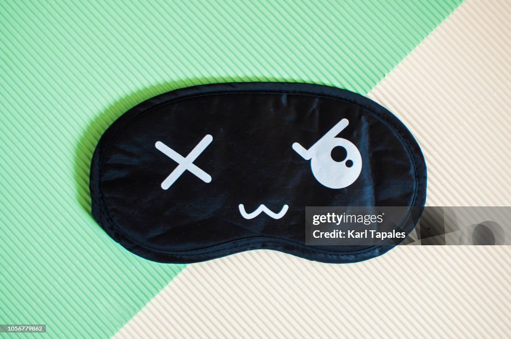 Flat lay of black and white sleep mask