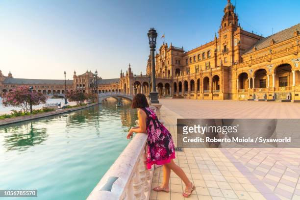 woman admires plaza de espana, seville - seville stockfoto's en -beelden