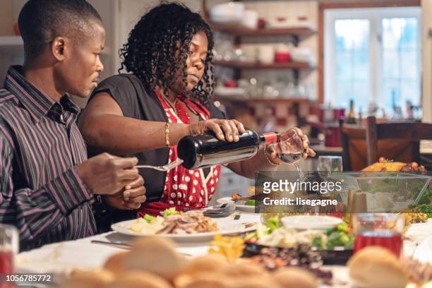african-american during thanksgiving dinner - twin girls stock pictures, royalty-free photos & images