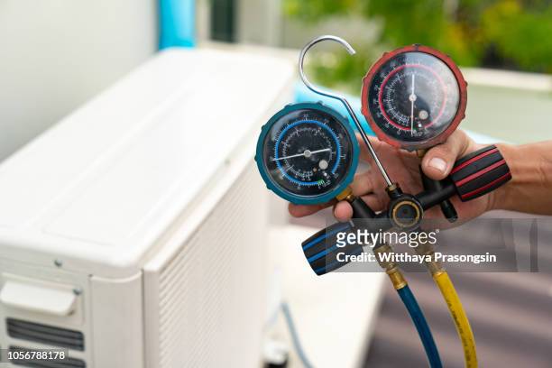 technician is checking air conditioner - hvac repair stock pictures, royalty-free photos & images