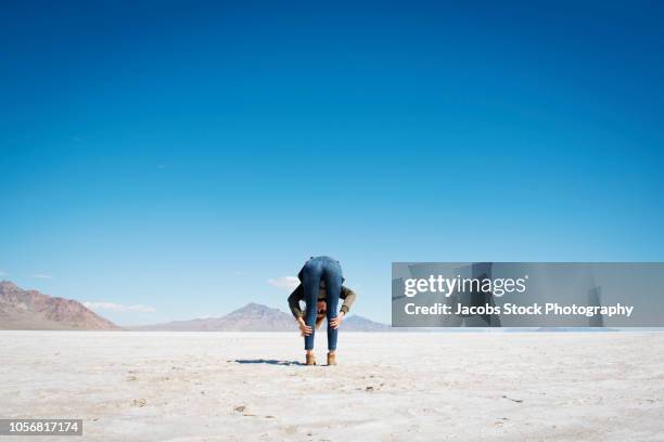 woman bending over - bending stock pictures, royalty-free photos & images