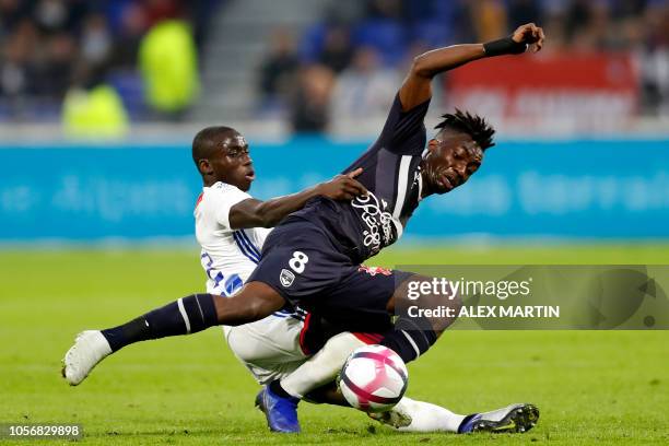 Lyon's French defender Ferland Mendy vies with Bordeaux' French forward Yann Karamoh during the French L1 football match between Olympique Lyonnais...