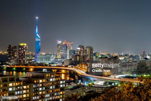 illuminated cityscape against sky at night - fukuoka prefecture - fotografias e filmes do acervo