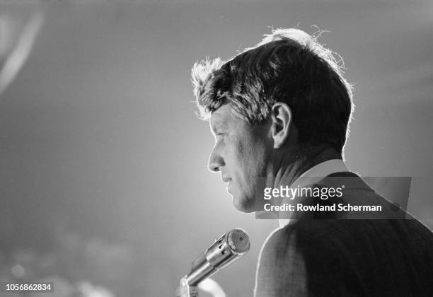 View of American senator Robert F Kennedy as he speaks into a microphone at an unspecifed rally during his campaign for the Democratic Party's...