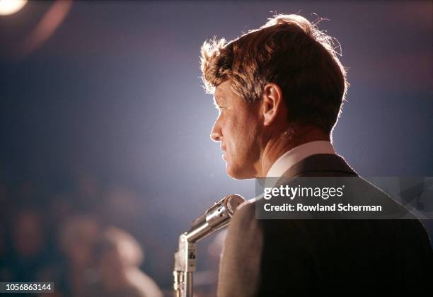 View of American senator Robert F Kennedy as he speaks into a microphone at an unspecifed rally during his campaign for the Democratic Party's...