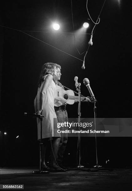 American musicians Joan Baez and Bob Dylan, the latter with an acoustic guitar, perform at the Newport Folk Festival, Newport, Rhode Island, July...