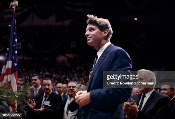 View of American senator Robert F Kennedy as stands to audience applause at an unspecifed rally during his campaign for the Democratic Party's...