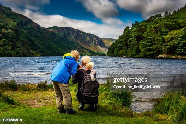 mother and son at glendalough upper lake - irish mother stock pictures, royalty-free photos & images
