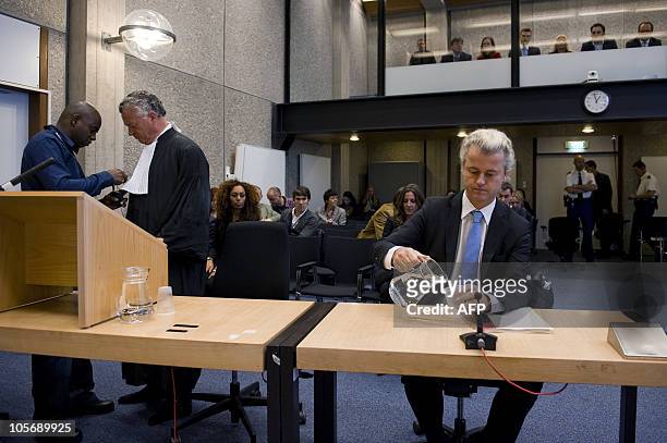 Dutch anti-Islam politician Geert Wilders waits for the start of his trial next to his lawyer Abraham Moszkowicz in the courtroom in Amsterdam,...