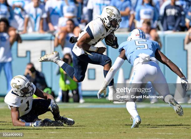 Patrice Rene of the North Carolina Tar Heels looks to tackle Tobias Oliver of the Georgia Tech Yellow Jackets in the first half of their game at...
