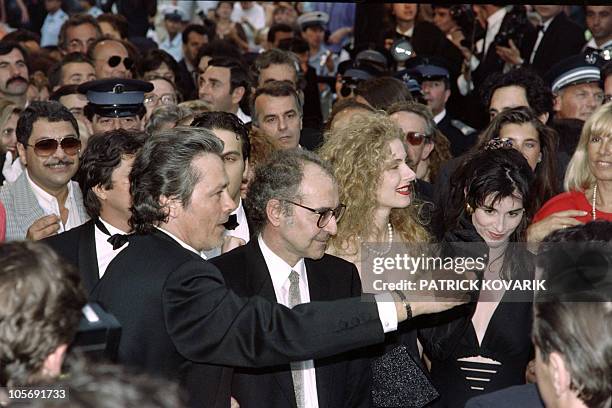 French actor Alain Delon, director Jean-Luc Godard and Italian actress Domiziana Giordano arrive for the screening of "Nouvelle vague", presented in...