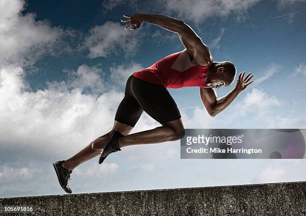 athlete sprinting up steady incline - leichtathletik stock-fotos und bilder