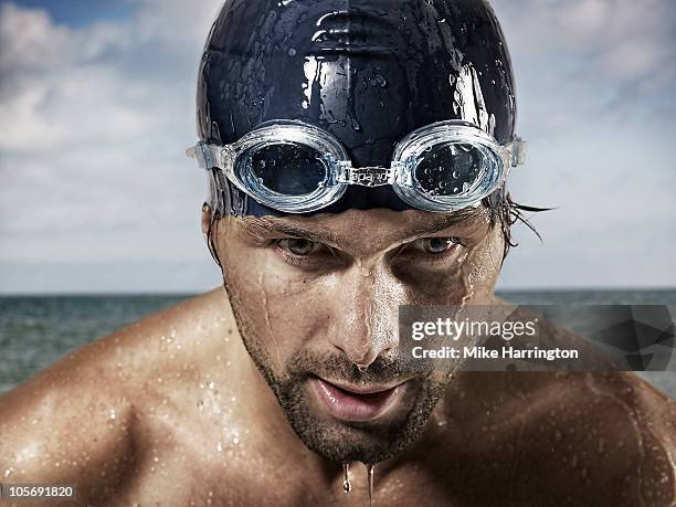 male swimmer standing by coast - occhialini da nuoto foto e immagini stock