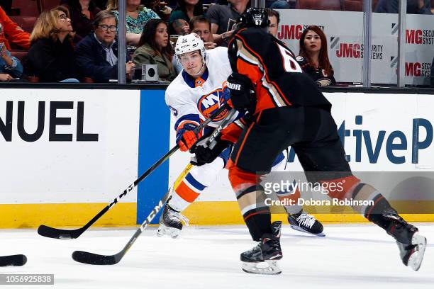 Mathew Barzal of the New York Islanders passes the puck against Rickard Rakell of the Anaheim Ducks during the game on October 17, 2018 at Honda...