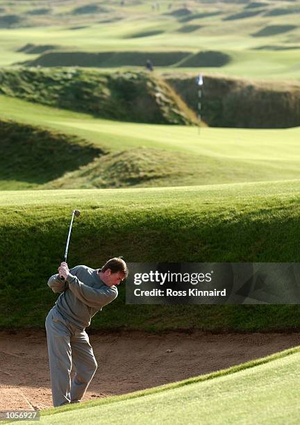 Kenny Dalglish plays out from a bunker on the sixth fairway at Kingsbarns Golf Links during the first official practise round during the inaugural...