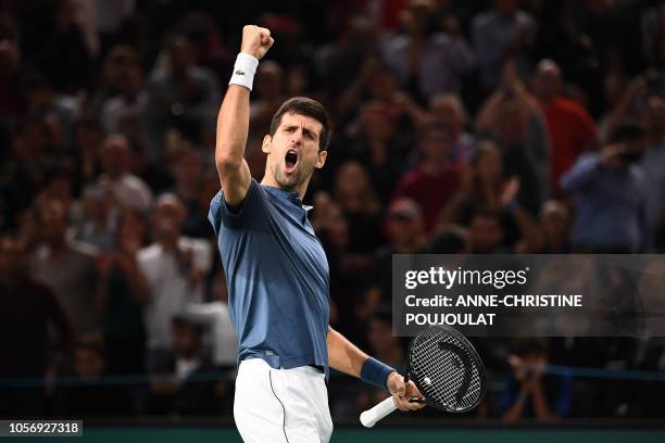 Serbia's Novak Djokovic celebrates after winning against Switzerland's Roger Federer at the end of their men's singles semi-final tennis match on day...