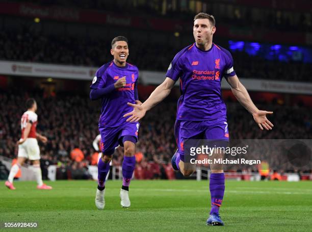 James Milner of Liverpool celebrates after he scores his sides first goal during the Premier League match between Arsenal FC and Liverpool FC at...