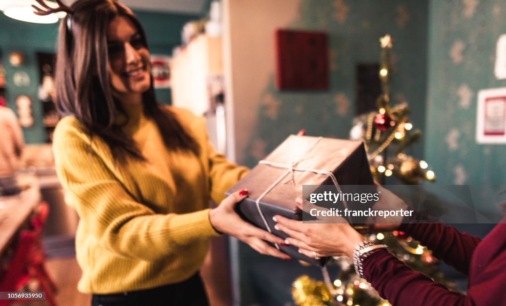 Friends exchanging christmas presents