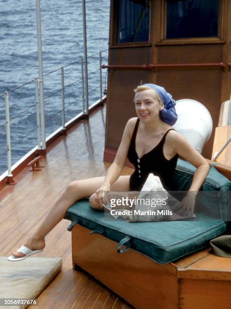 American comedienne, actress, singer and businesswoman Edie Adams poses for a portrait while reading the newspaper circa 1959 on a yacht near Santa...