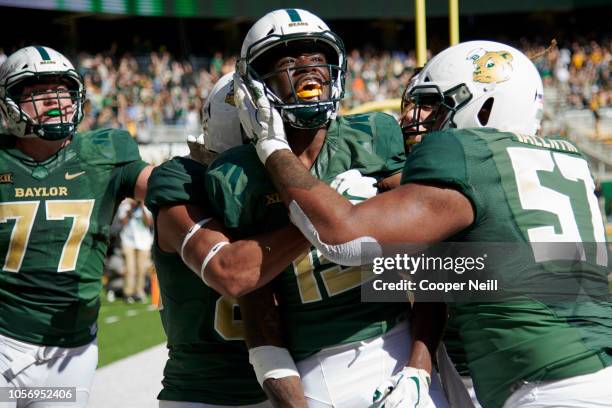 Denzel Mims of the Baylor Bears celebrates with his teammates after scoring the game winning touchdown on a 6 yard reception against the Oklahoma...