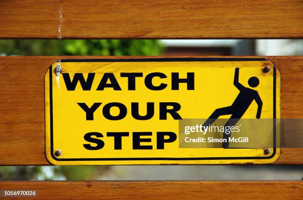 'watch your step' sign on a gate - slippery stock pictures, royalty-free photos & images