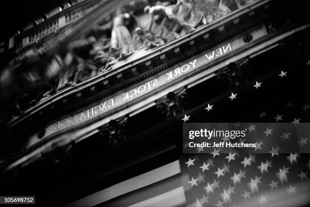As the world's economy struggles to pull out of a recession, the facade of the New York Stock Exchange is reflected in a buidling across the street...