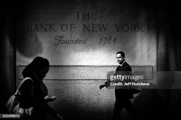 Businessman walks by the Bank of New York in Midtown Mahattan, home to many of the world's banks on April 9, 2009 in New York City.