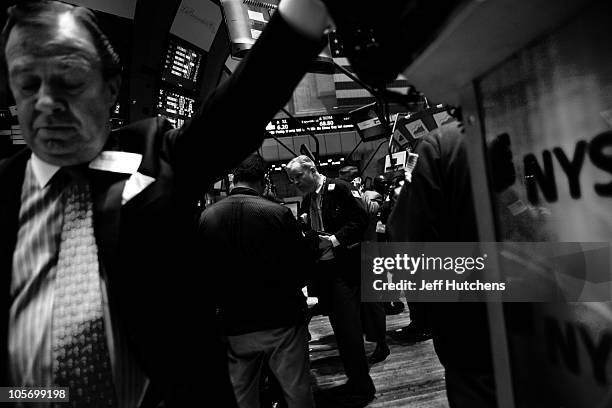 As the world's economy struggles to pull out of a recession, traders work on the floor of the New York Stock Exchange in the New York financial...
