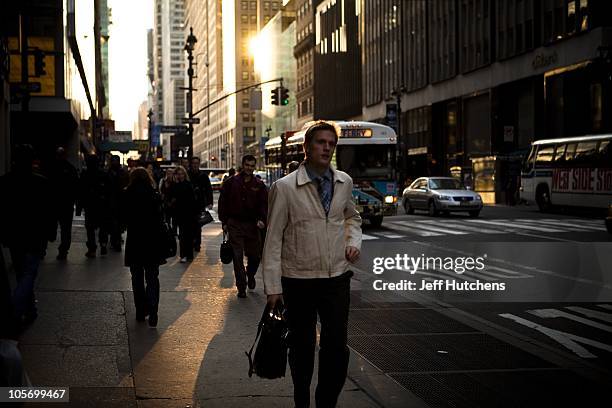 Pedestrians travel the streets during the late afternoon rush hour in Midtown Mahattan, home to many of the world's banks on April 9, 2009 in New...