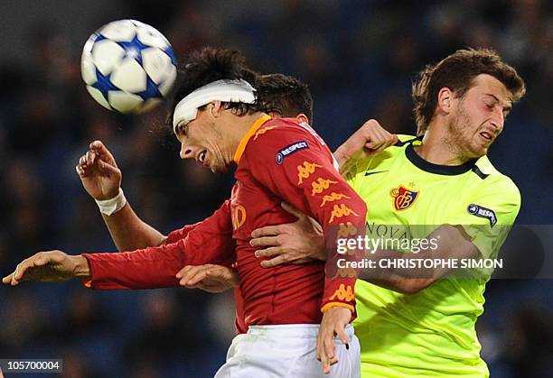 Roma's Argentinian defender Nicolas Burdisso fights for the ball with FC Basel's defender David Angel Abraham during their group E Champion's League...