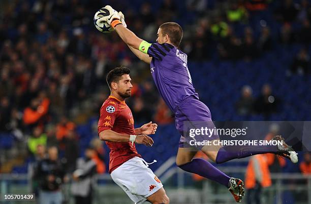 Basel's goalkeeper Franco Costanzo jumps for the ball in front of AS Roma's forward Marco Borriello during their champions league football match on...